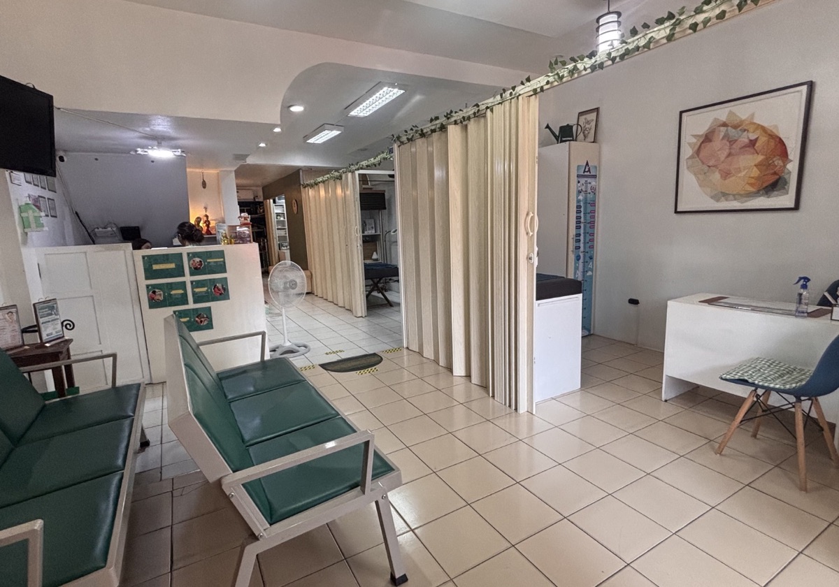 The Care Center waiting area, with seating, curtained consultation bays and the reception desk beyond
