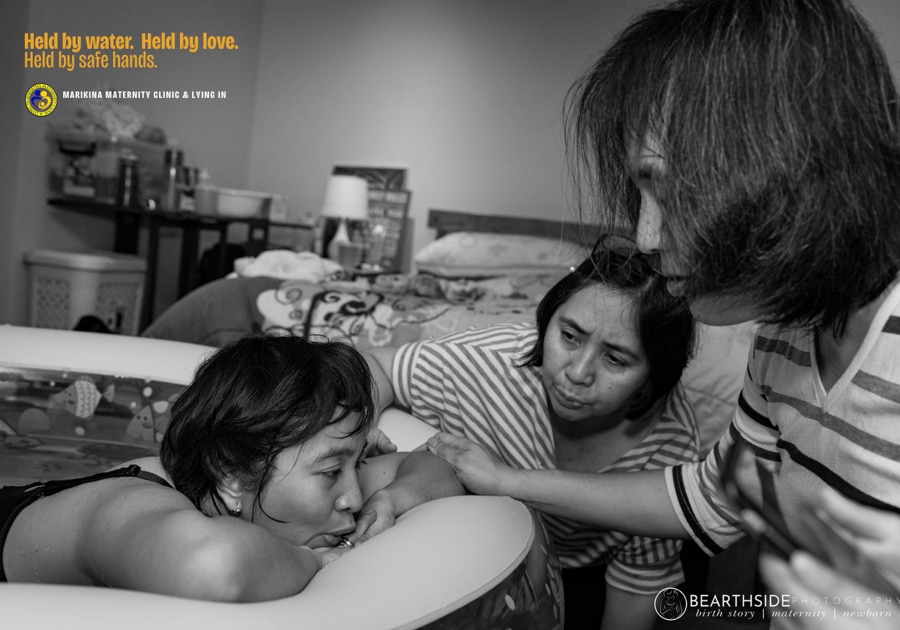 A mother supported by her birth team during labor