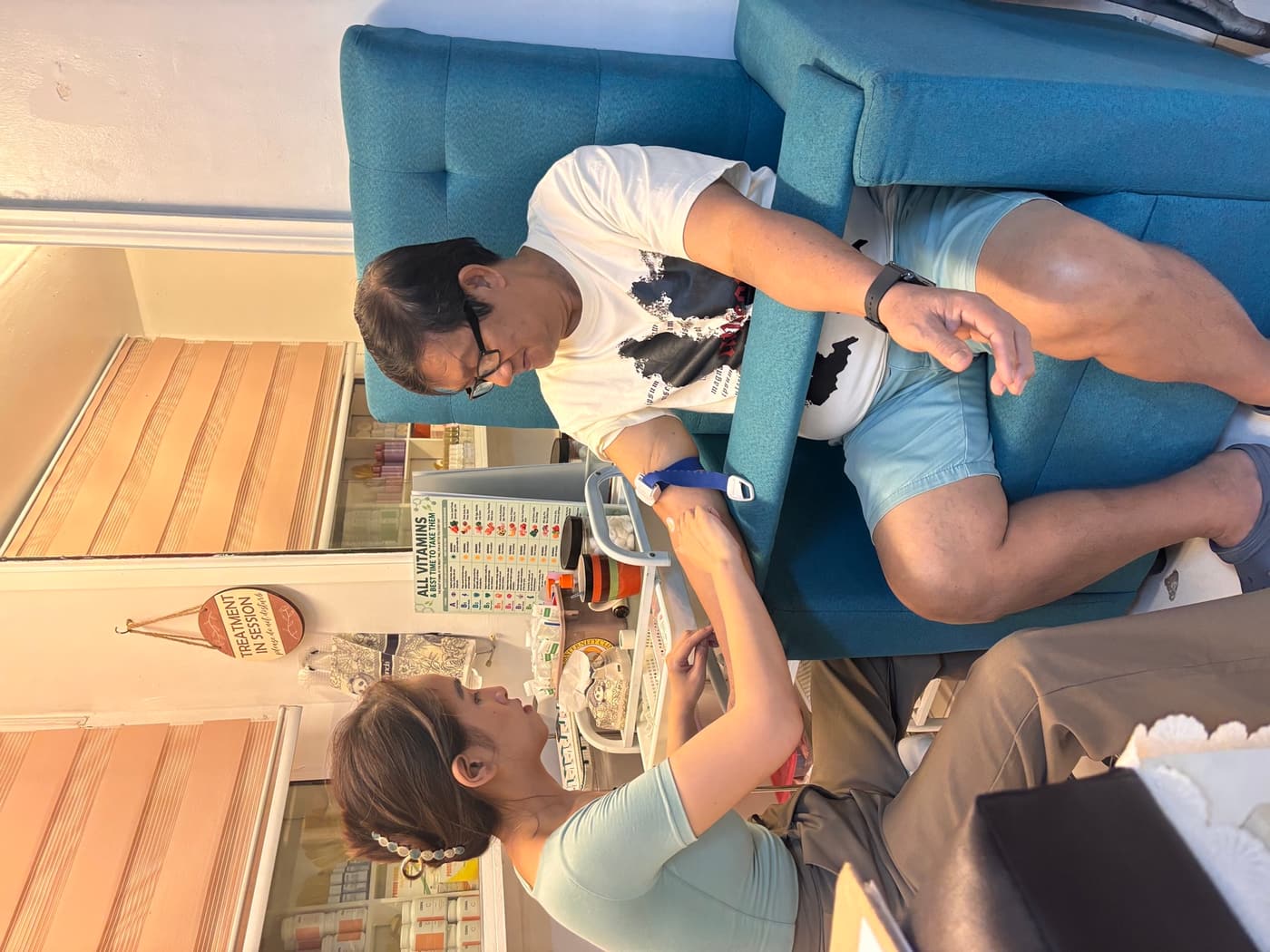 Child client receiving supervised micronutrient support with an adult present